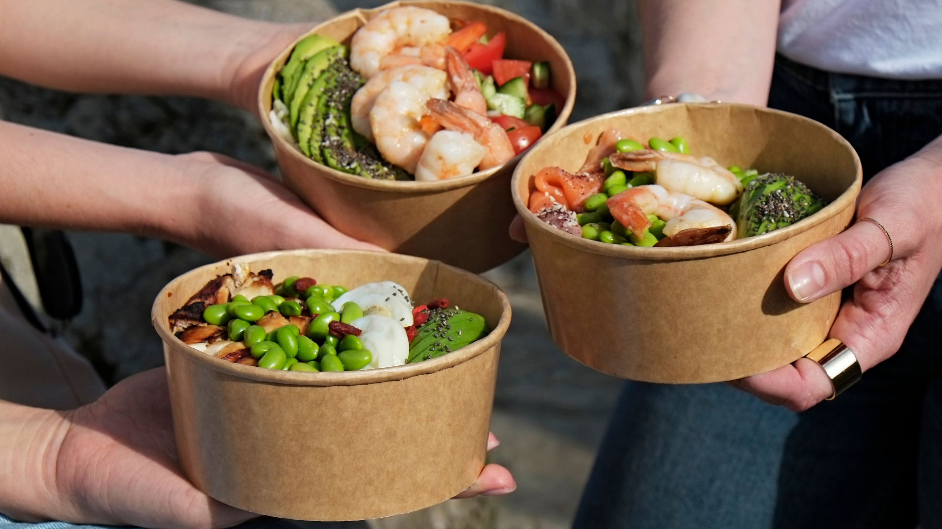 Eco-friendly kraft takeout bowls filled with fresh shrimp, avocado, and edamame showcasing sustainable and visually appealing food packaging.